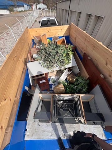 Full dump trailer loaded with junk — overhead view